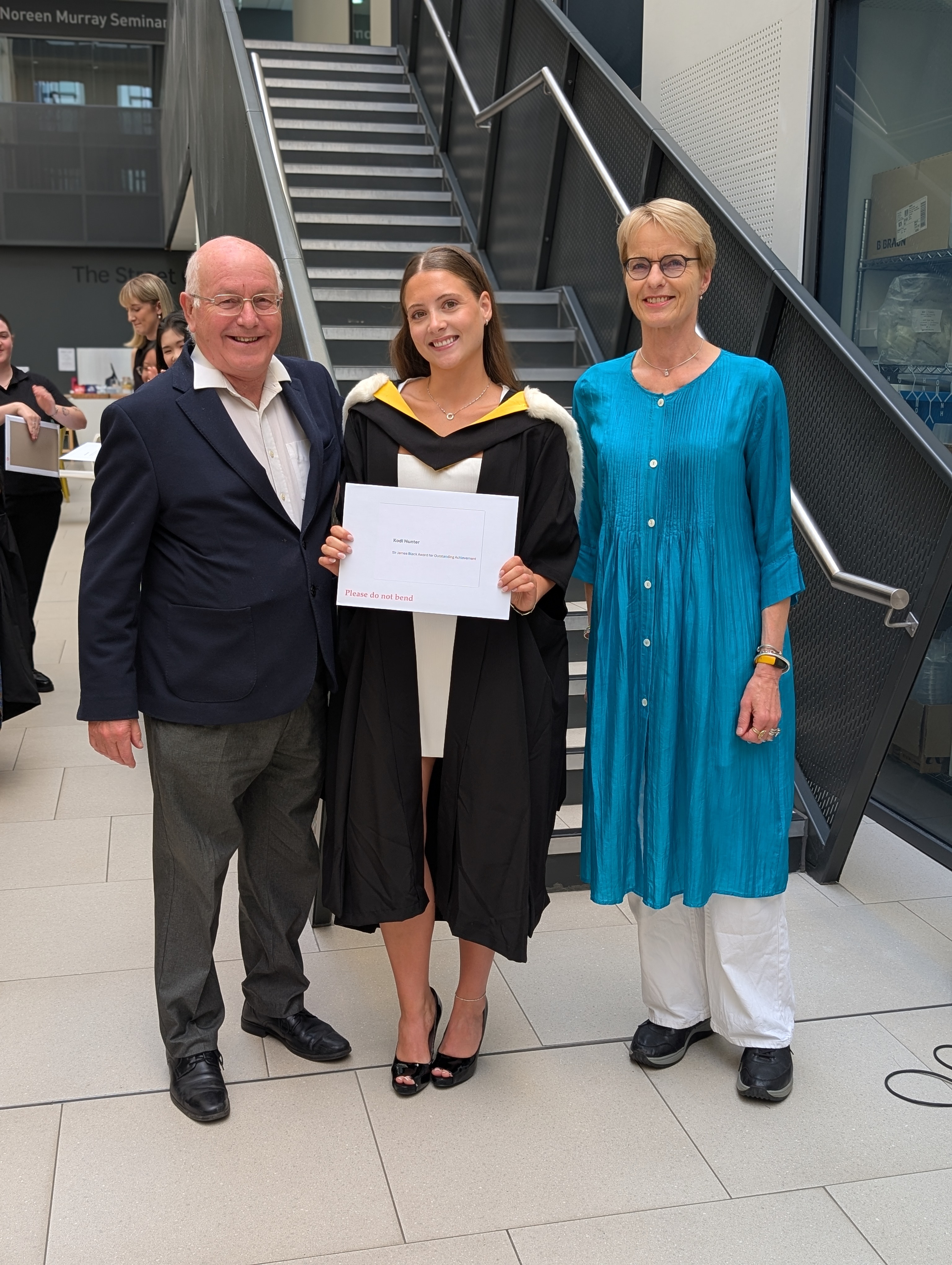 Kodi Hunter with the Sir James Black award. To the right, Professor Inke Nathke, Deputy Dean of Life Sciences, who presented Kodi with the award. To the left, Philip Cohen