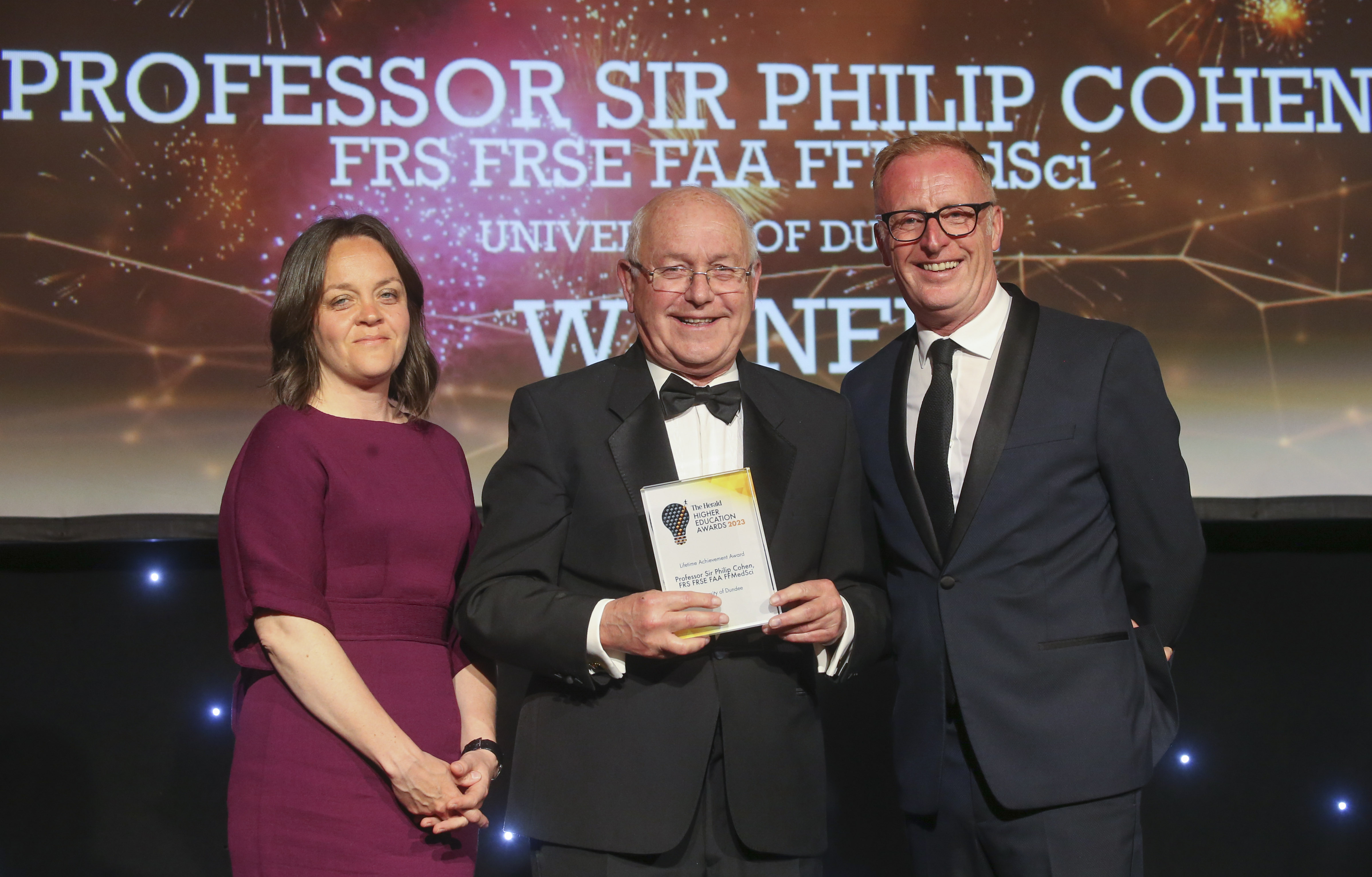 Philip receiving the award from Herald Editor Catherine Salmond and TV and radio personality Bryan Burnett, who was the compere for the evening