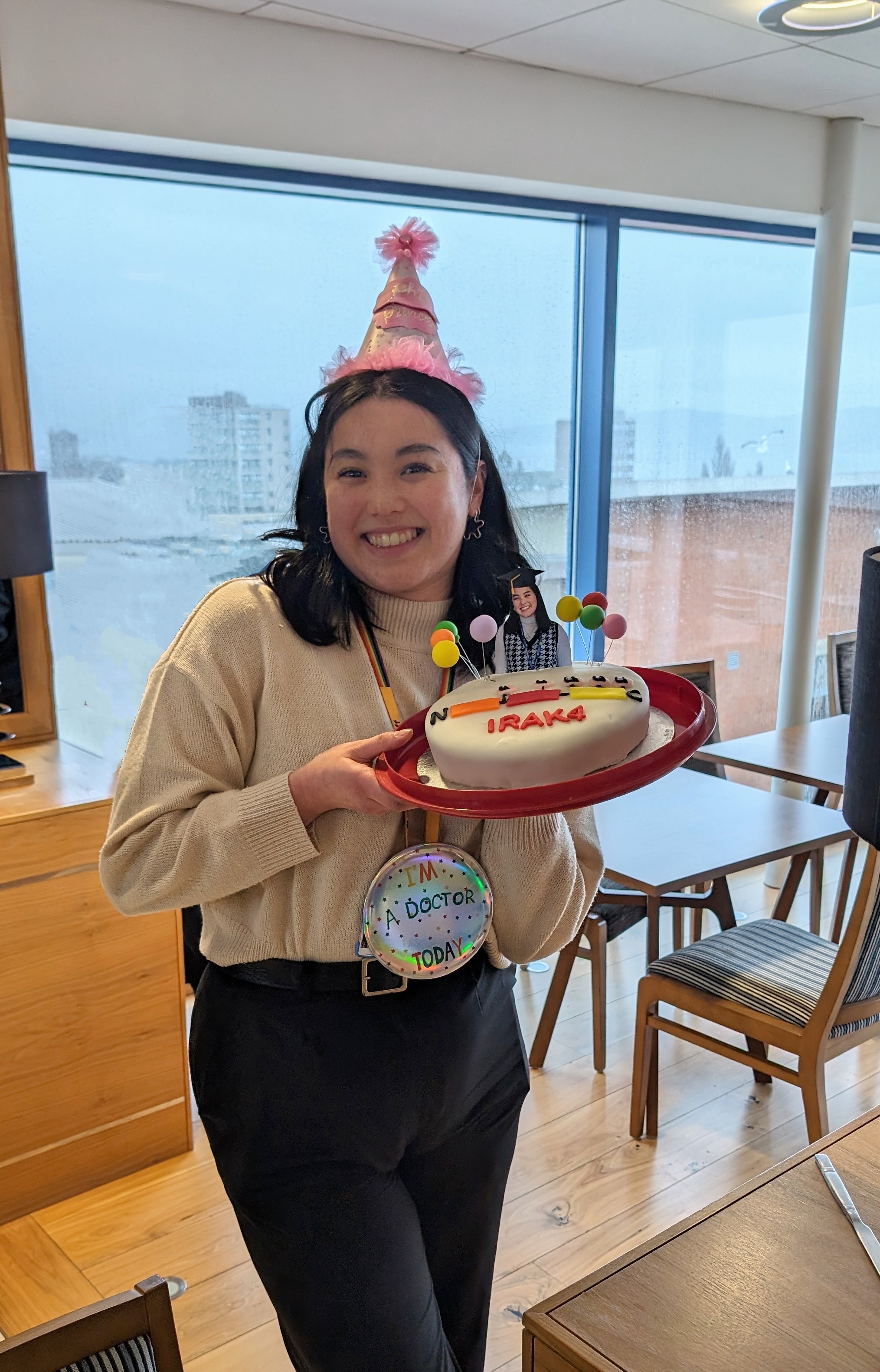 Elisha at the reception after the Viva holding her celebration cake cooked by tsvetana Petrova, a postdoctoral researcher in Philip Cohen’s lab