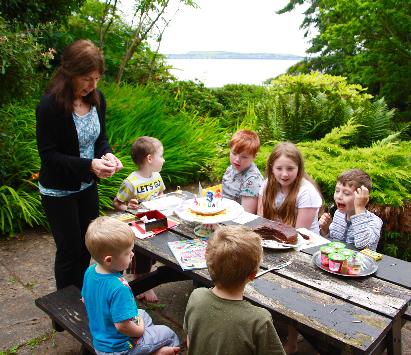 Tricia with her six grandchildren in her garden 2016