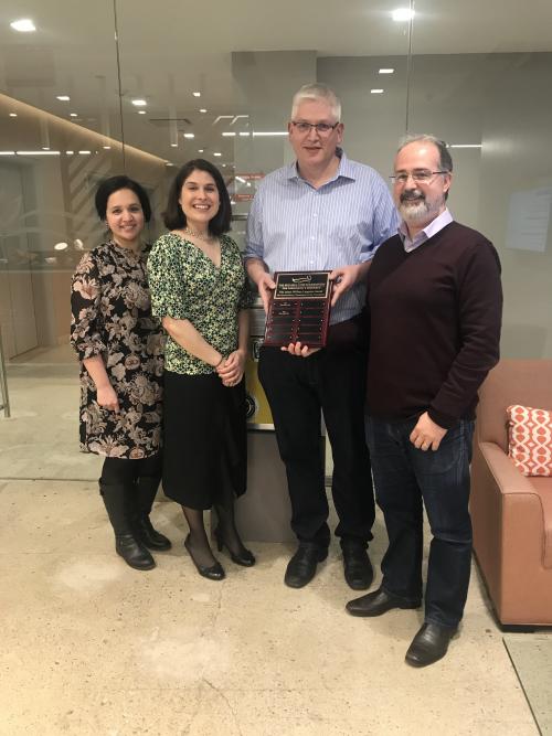 Dario Alessi being presented with the Langston Award by Shalini Padmanabhan, Terina Martinez and Marco Baptista